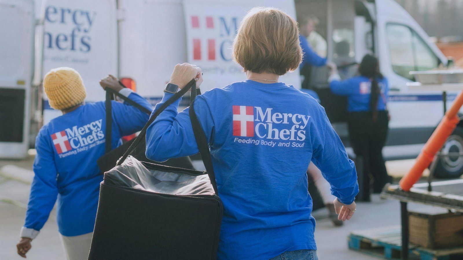 Mercy Chefs crew serving hot meals to flood-affected families
