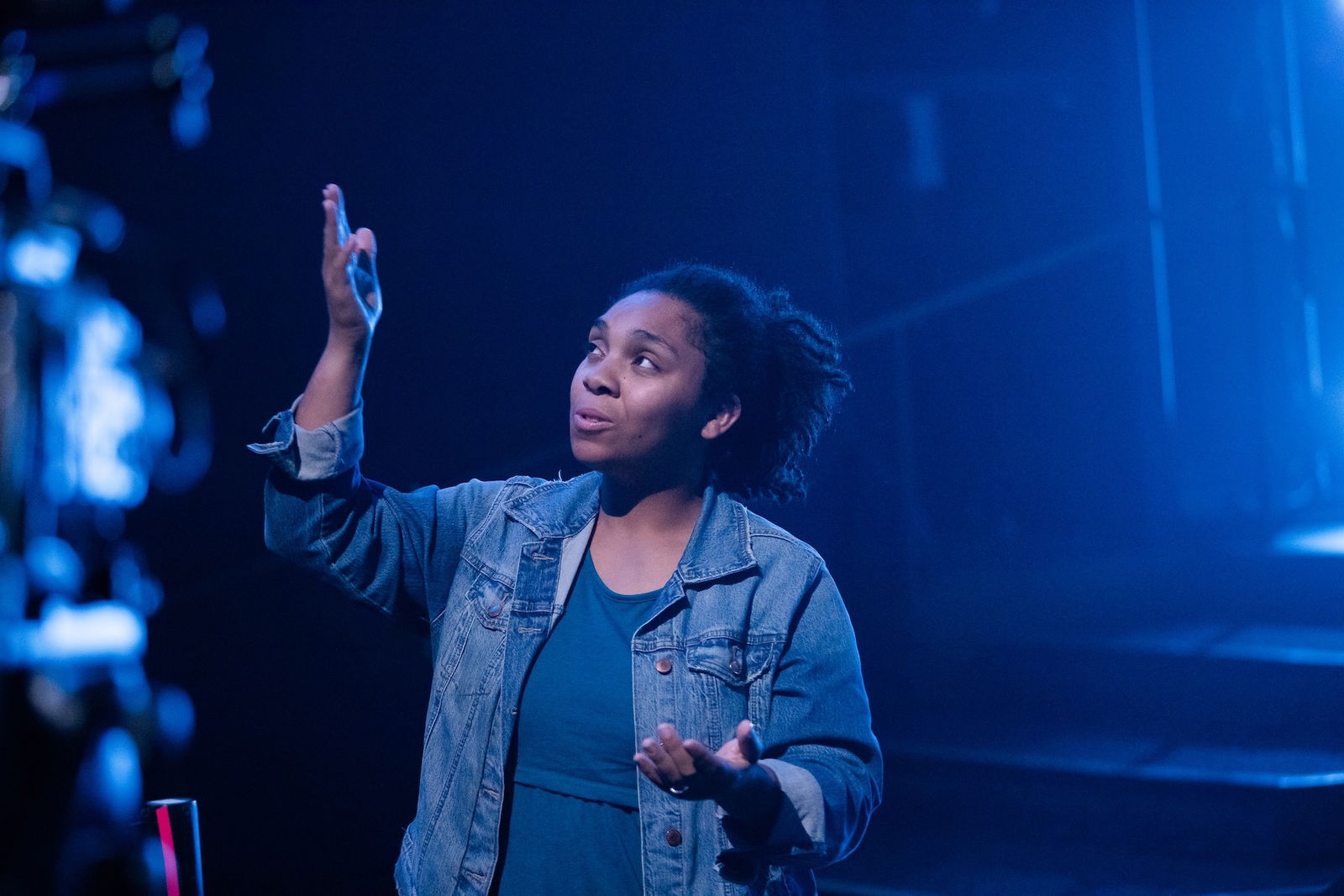 People standing around a woman in prayer